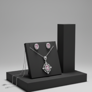 A matching set of pink oval gemstone necklace and stud earrings displayed on a black geometric stand.