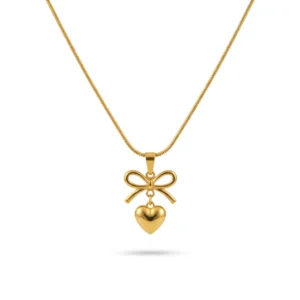 Gold bow necklace with a dangling heart pendant on a thin snake chain.