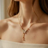 Gold butterfly necklace with diamond pave and hanging chain tassels.