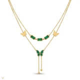 Gold layered necklace with green stones and butterfly pendant.