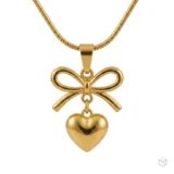 Gold bow necklace with a dangling heart pendant on a thin snake chain.