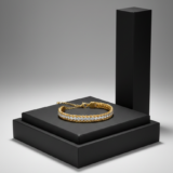 Luxury gold chain bracelet with a row of sparkling white crystals on a black pedestal.