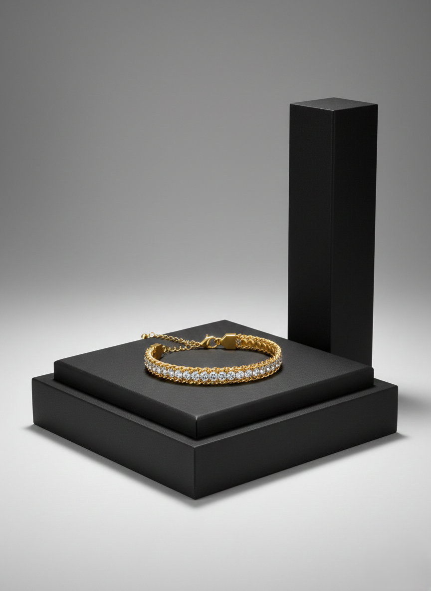 Gold-Plated Diamond Tennis Bracelet on Display Luxury gold chain bracelet with a row of sparkling white crystals on a black pedestal.