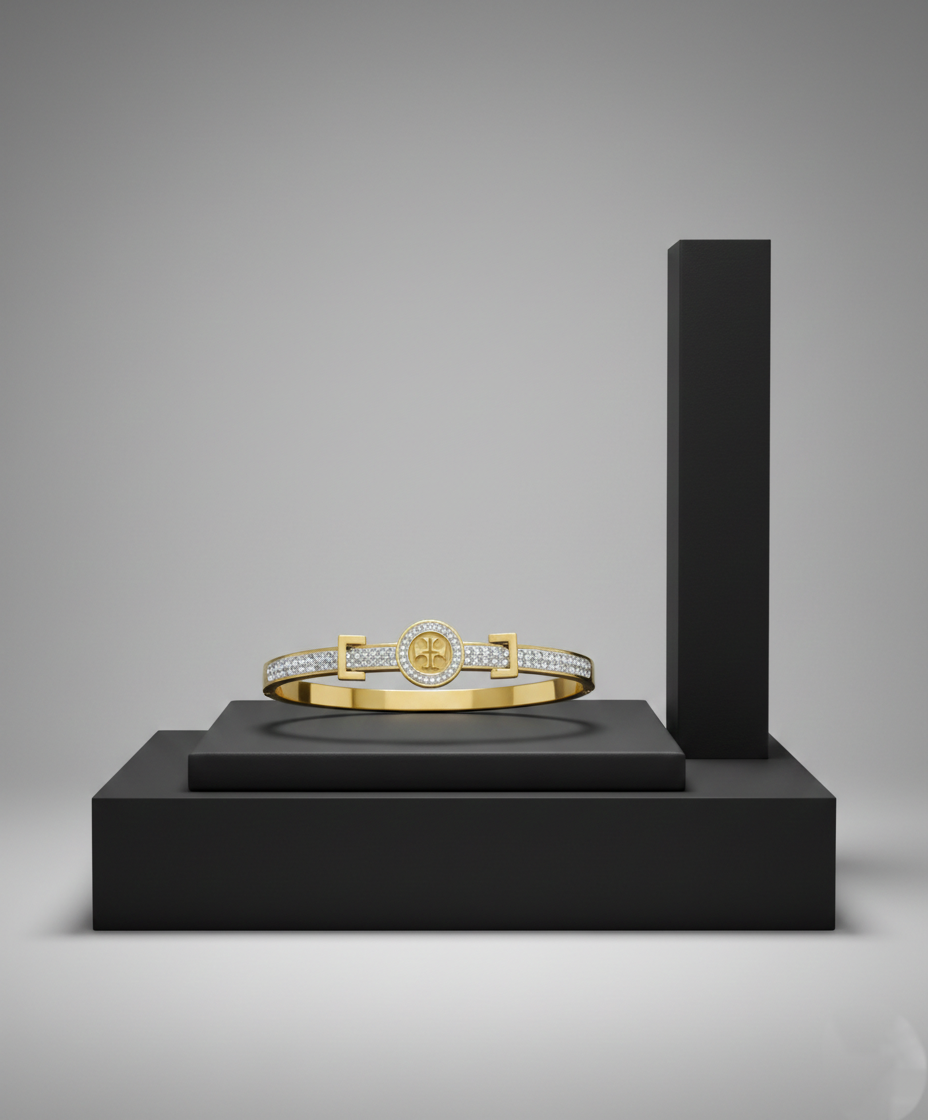 Luxurious Gold Bangle with Diamond Accents on Minimalist Display A gold bangle bracelet featuring a central circular emblem and diamond-encrusted bands, displayed on a black geometric pedestal.