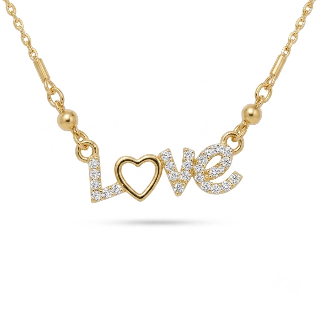 Gold script necklace spelling "Love" with a paved crystal heart as the letter O.