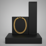 A multi-strand gold chain necklace displayed on a black geometric pedestal against a grey background.