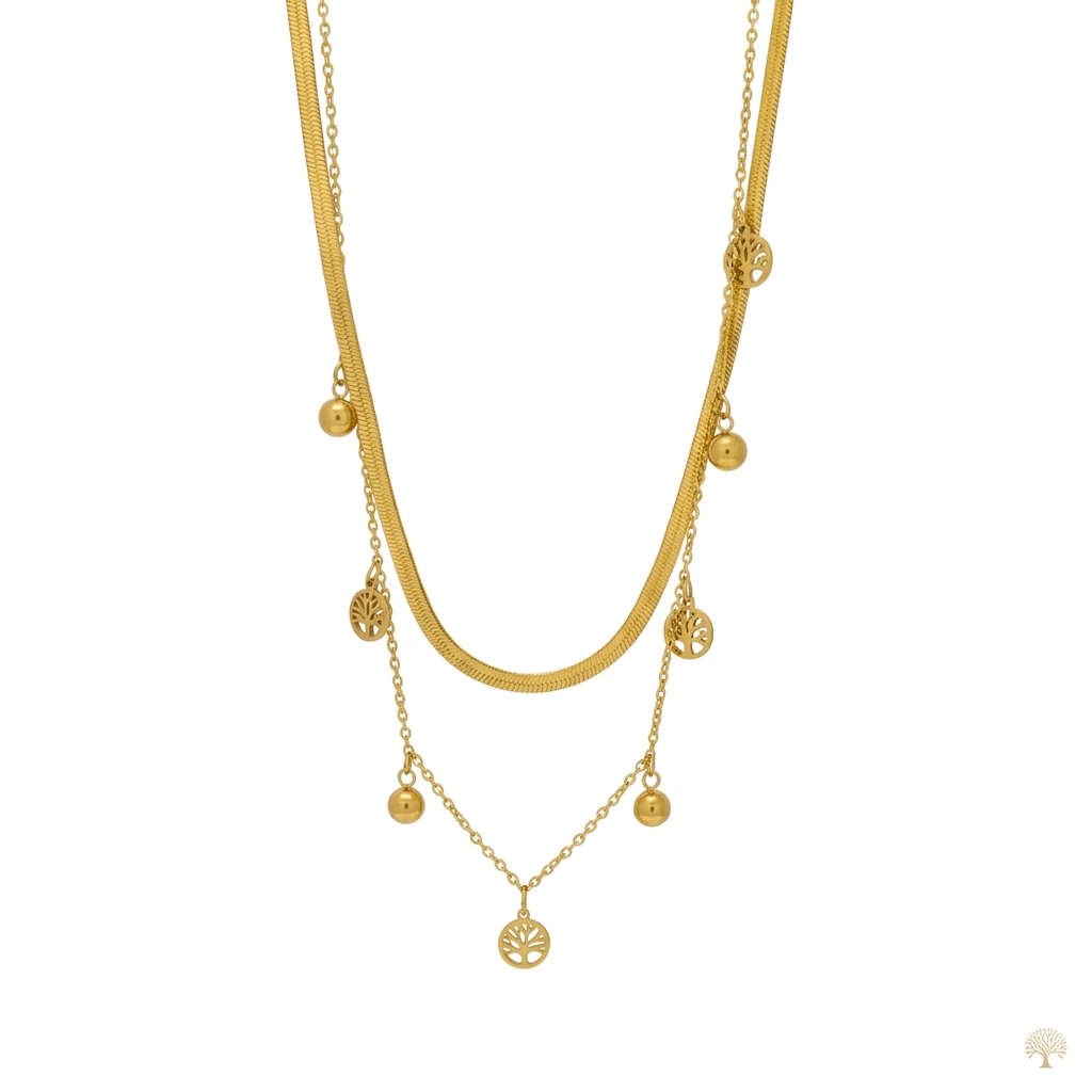 Layered gold necklace with flat herringbone chain and tree of life charms.