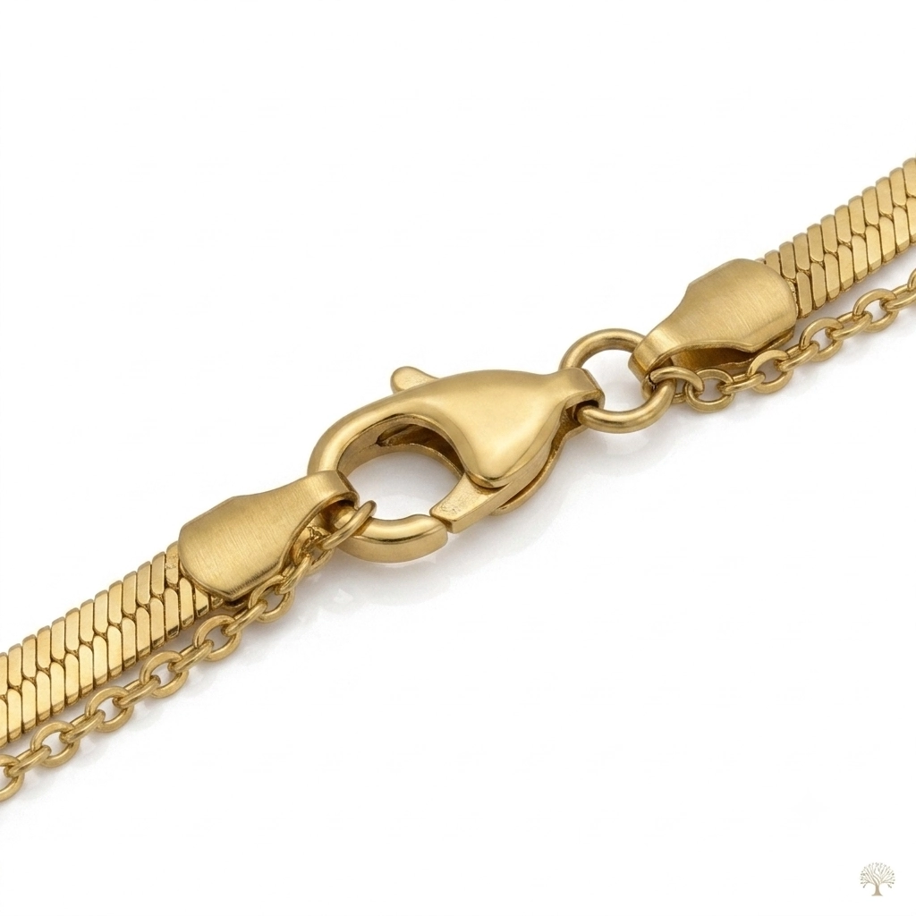 Layered gold necklace with flat herringbone chain and tree of life charms.
