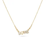 Gold script necklace spelling "Love" with a paved crystal heart as the letter O.