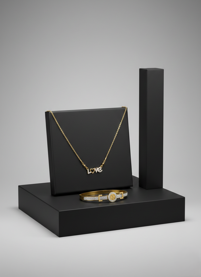 Gold and Diamond "LOVE" Jewelry Set on Minimalist Display A gold necklace with a diamond-encrusted LOVE pendant and a matching gold bangle on black display stands