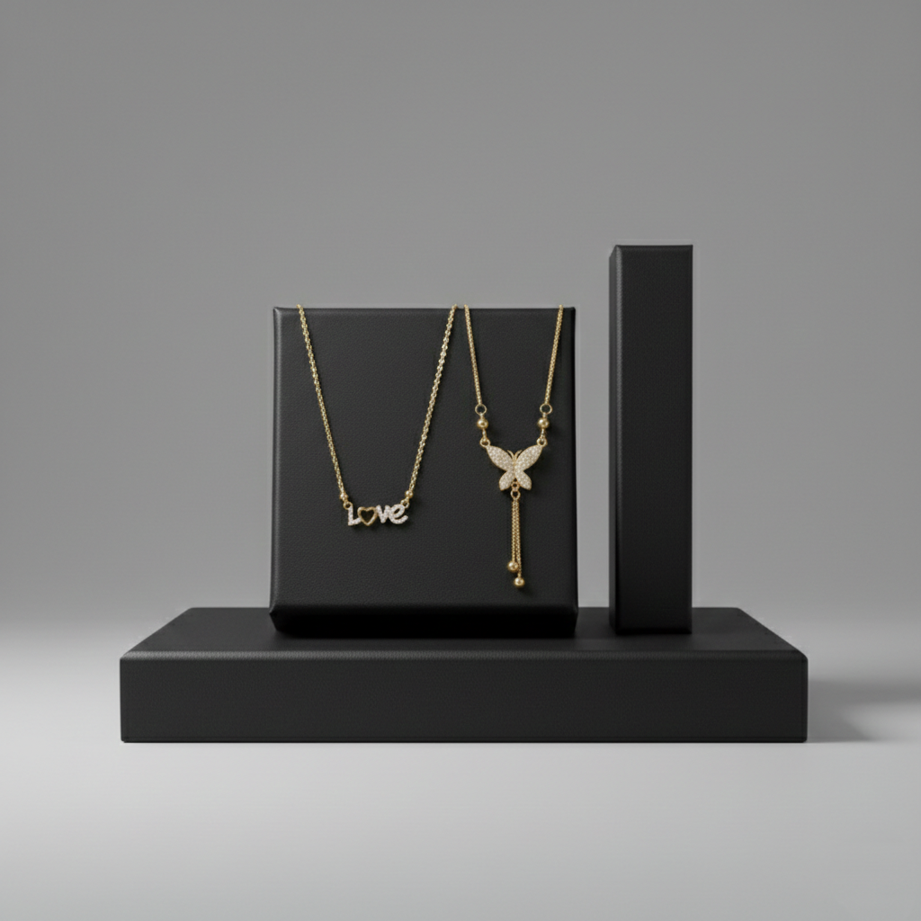 Gemini said This is a sleek, professional shot. Here is the optimized copy for your website’s product listing: Image Title: Elegant Gold "Love" and Butterfly Necklace Set on Black Display Two gold necklaces, one with a "Love" script pendant and another with a crystal butterfly tassel, displayed on black matte blocks.