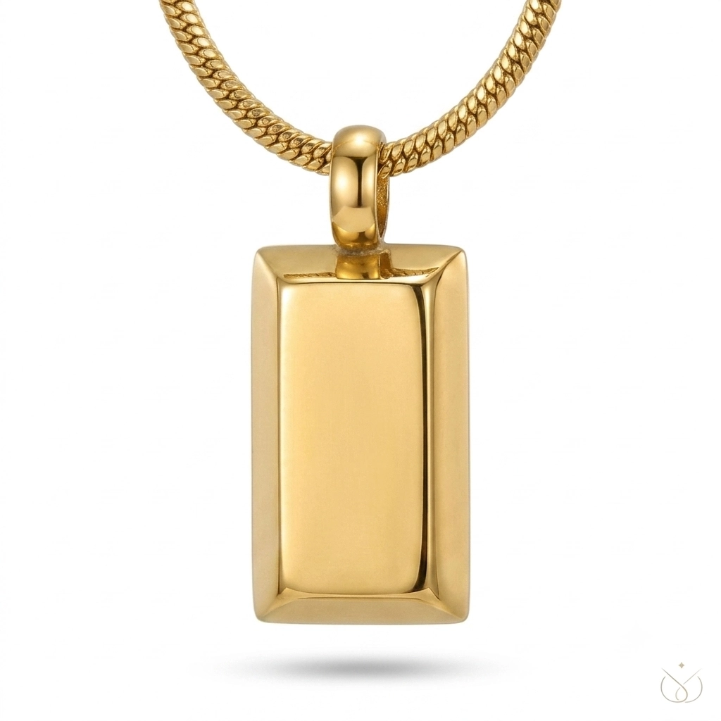 : Close-up of a gold bar pendant on a thick snake chain.